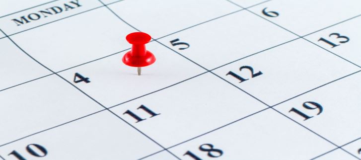 calendar with red thumbtack marking a date