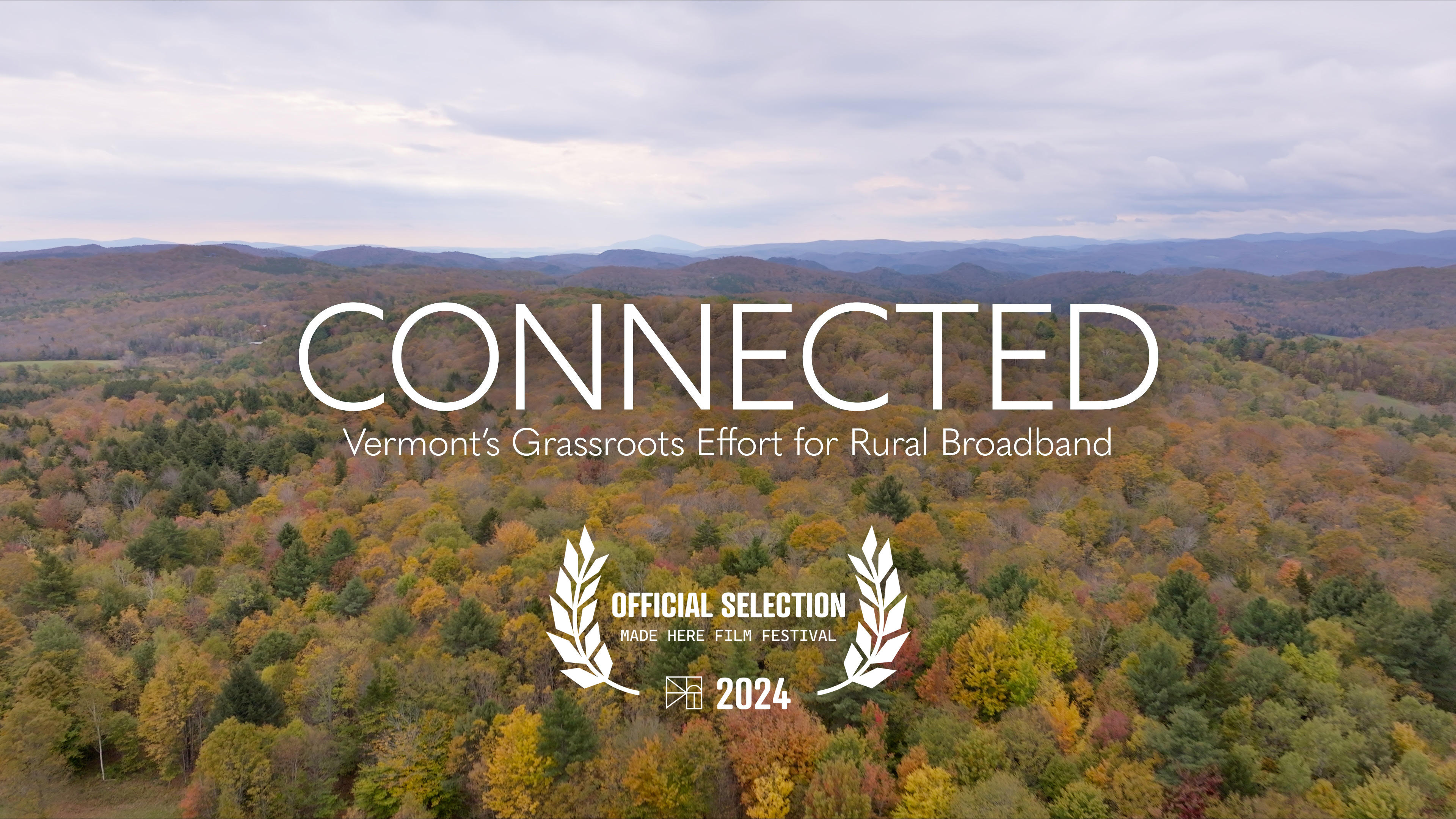 Title shot from "Connected" documentary showing a view from above of a Vermont landscape of trees with changing leaves.